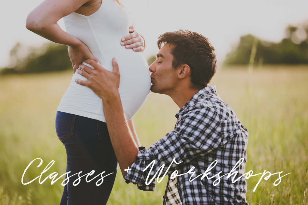 Birth Classes Header: father kissing pregnant belly in a field